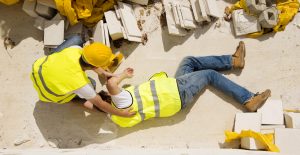 Construction worker helping fellow employee suffering from an injury