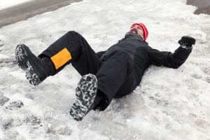 Man falling on his back from icy pavement