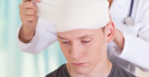 Man receiving head wrap from injury