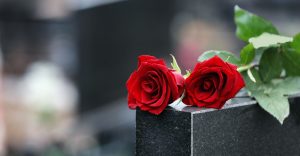 Roses on top of a granite gravestone