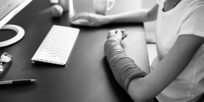 Remote employee typing on keyboard for workers comp blog post