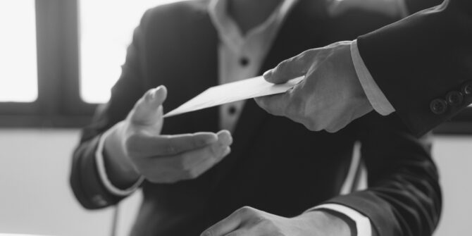 Workers comp attorney handing client workers comp payment