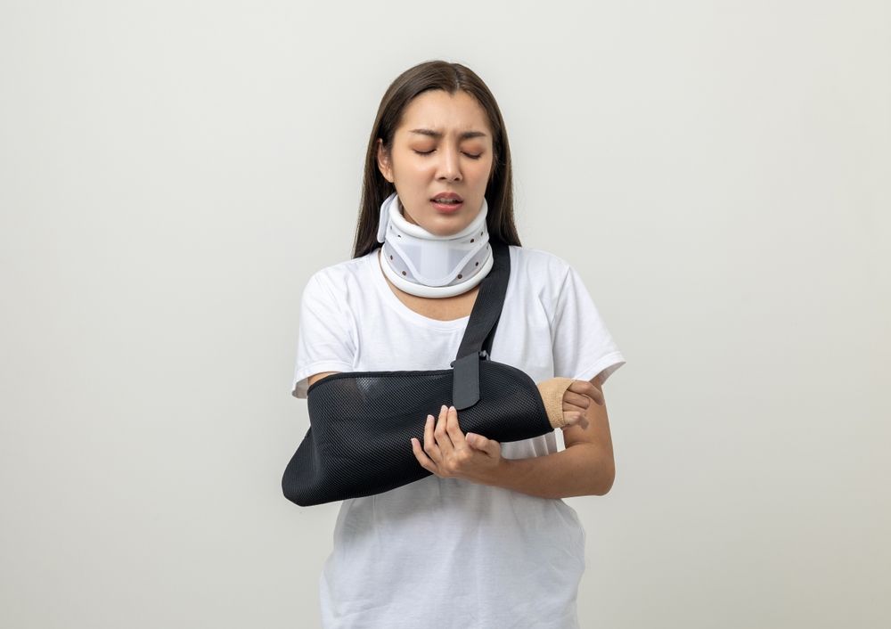 depressed woman in cast holding arm